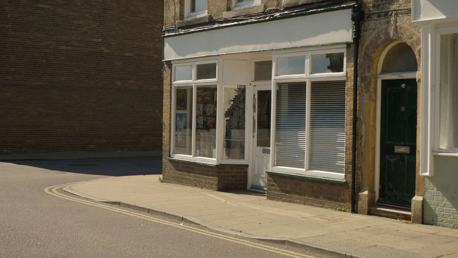 The frontage of a small independent commercial building on a bright, dry morning